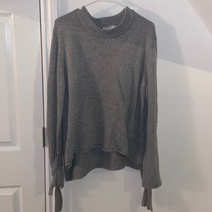 Skylar+Madison grey knit sweater with hanging ties at the wrist. size M